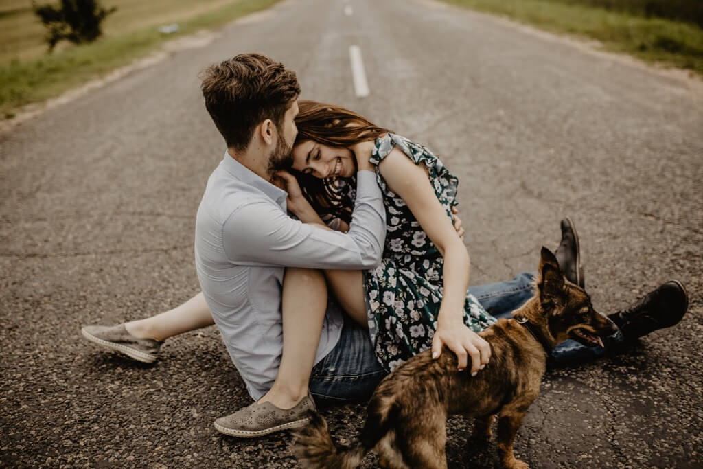 couple sitting on a road
